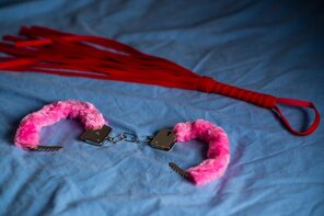 amateur pic handcuffs-with-red-fur-whip-devices-love-games-bed_209484-11897