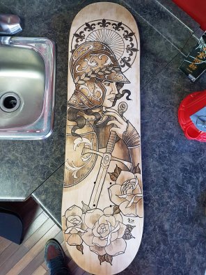 Joan of Arc, wood stain markers and acrylic on skateboard, 8" Ã— 32"
