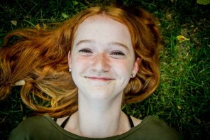 Happy redhead on the grass