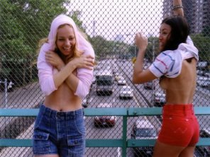 Two cute embarrassed girls flashing their boobs on a bridge