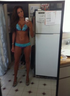 Heels and bikini in the kitchen.