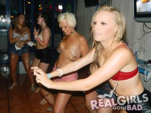 amateur photo Girl smiles as she covers her boobs during a competition in a bar