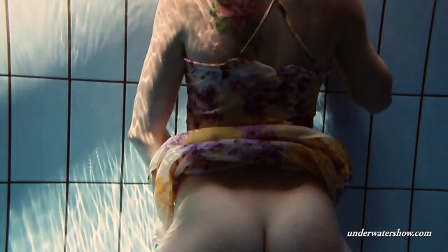 Floating babe in the swimming pool naked